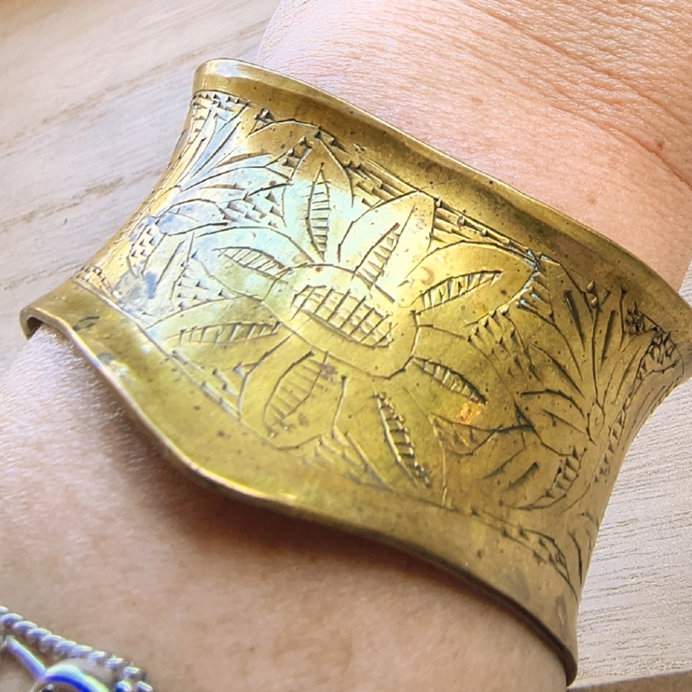 vintage wide, brass-toned bracelet cuff with an etched floral design